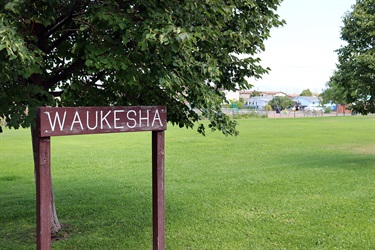 Wood sign at Waukesha Park.